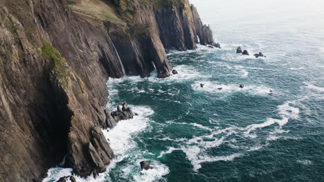 pacific ocean waves crashing against oregon coast cliffs, static aerial