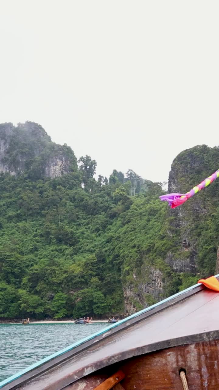 Boat journey past lush cliffs in Krabi, Thailand
