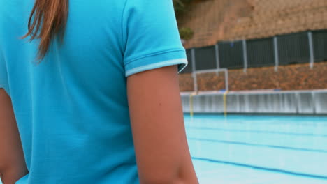 girl standing near the swimming pool