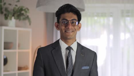 Young-professional-adjusting-his-tie-on-his-suit-before-smiling-at-camera