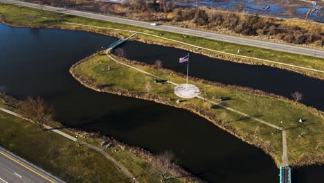 american flag flapping in the wind over the causeway