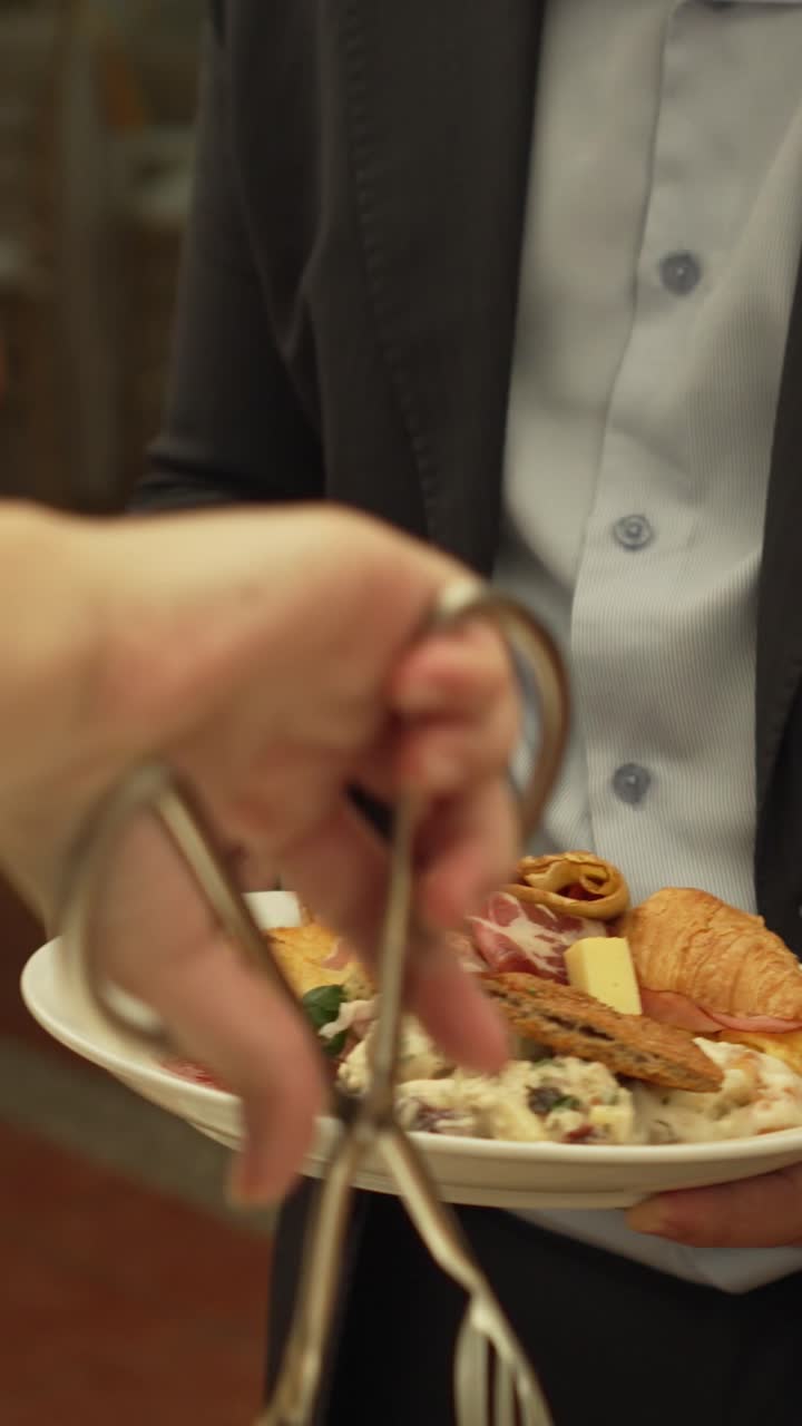 A group of people are serving food at a buffet. Scene is casual and social event. Brunch catering.