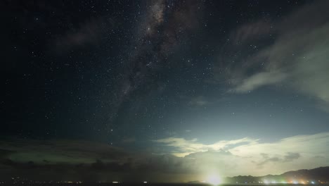 night sky with milky way and city lights