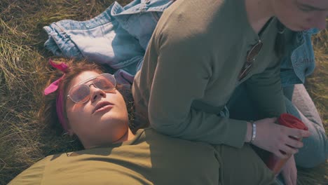 overweight girl and partner rest after hike on green grass