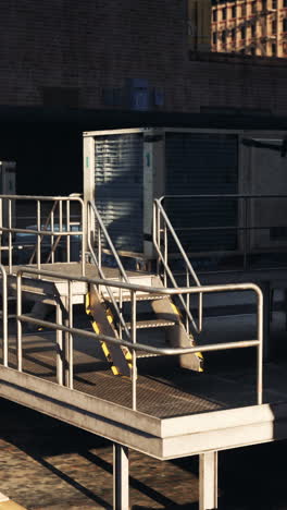 metal stairs leading to ac unit on a rooftop