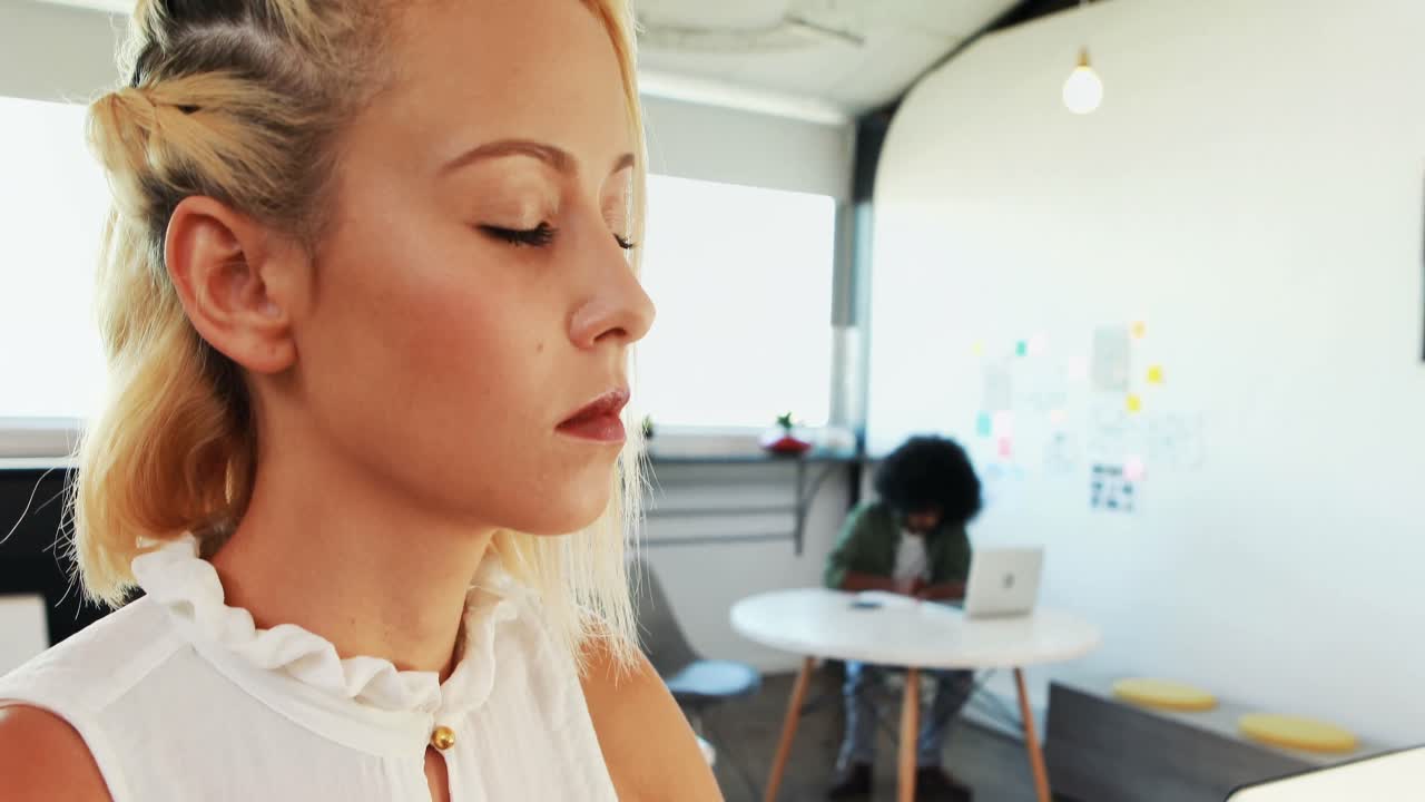 Female executives doing yoga in office 4k