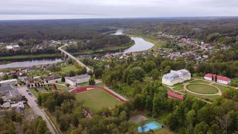 aerial view of a picturesque town with a castle and river