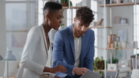 african american business woman team leader brainstorming with colleague using laptop computer showing ideas pointing at screen working together in office