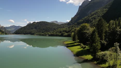 Majestätische-Gipfel,-Kristallklares-Wasser:-Luftaufnahme-Von-Grünen-Wäldern-Und-Bergen-Am-Seeufer