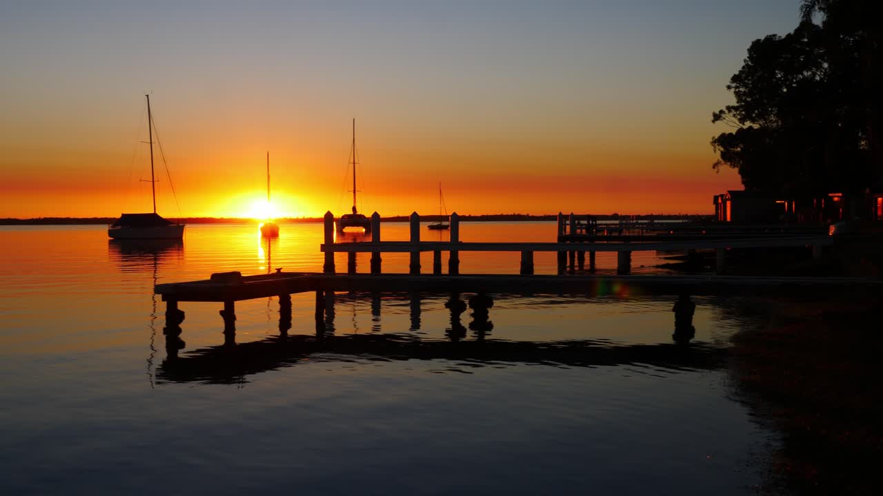 sailing boats and yachts floating on lake macquarie new castle
sunrise sunlight reflection over thje lake