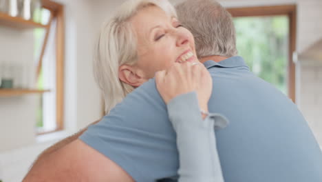 Senior-couple,-hug-and-smile-in-home-for-love