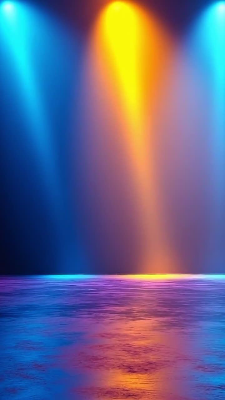 Bright lights set vibrant mood. Bright beams of colored light illuminate a shiny surface, enhancing the energetic vibe of the performance space.