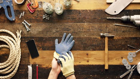 putting on work gloves in a workshop