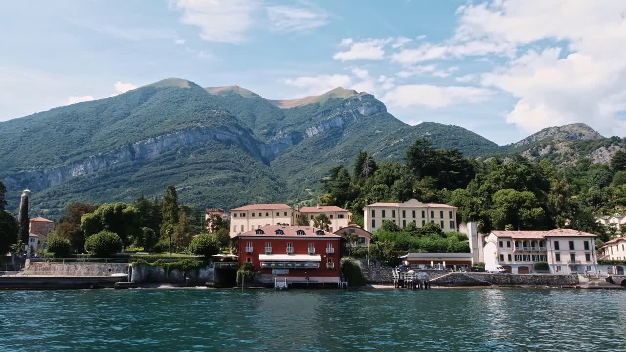 LOMBARDY, ITALY - AUGUST 02, 2018: Cinematic shot of Bellagio town, Como lake and mountains from a boat
