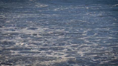 Gentle-ocean-waves-wash-over-the-rocky-beach-in-Tenerife