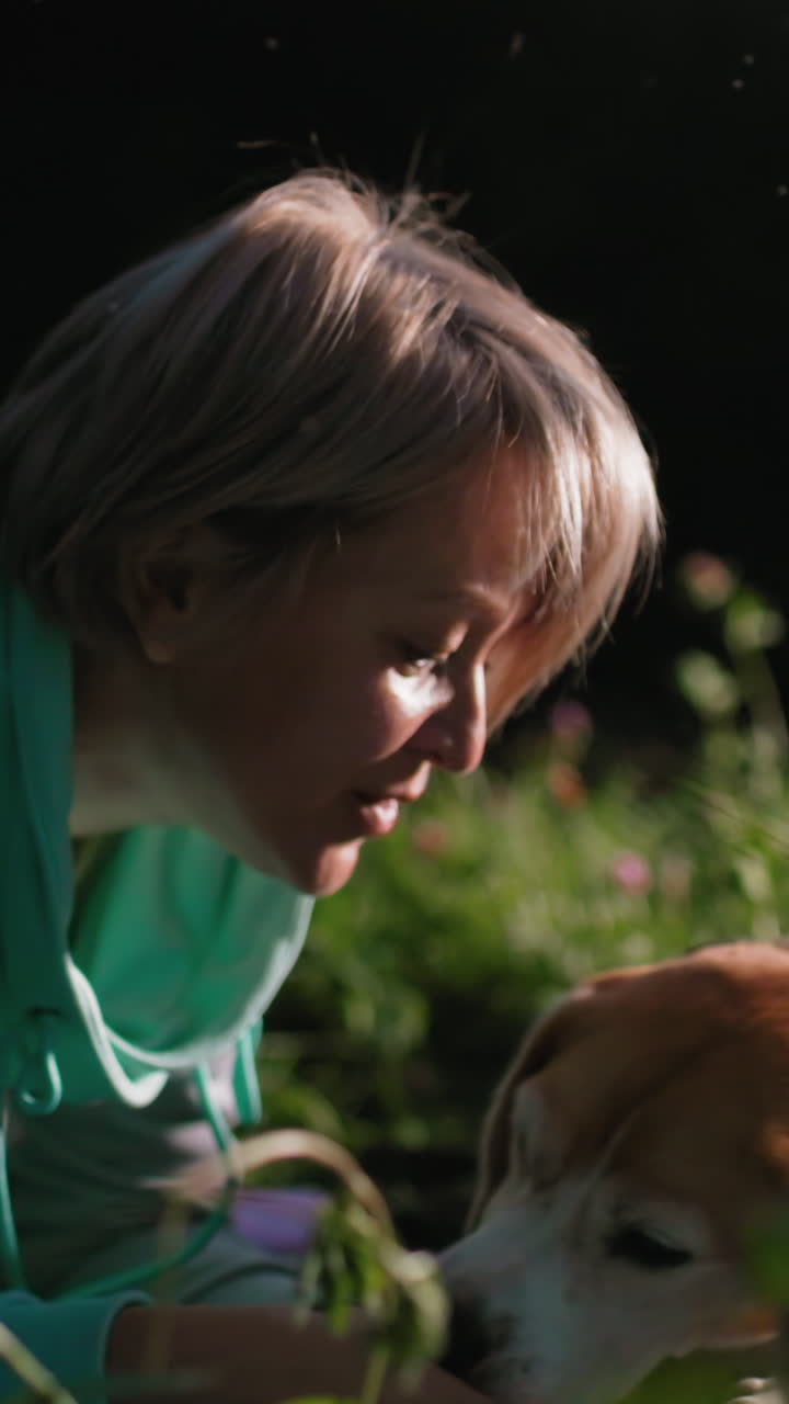 Woman with smiling beagle enjoying sunny day outdoors, Female pet owner shares cheerful moment with her beagle in sunlight, Woman and her beagle happily engage in outdoor setting under bright sun