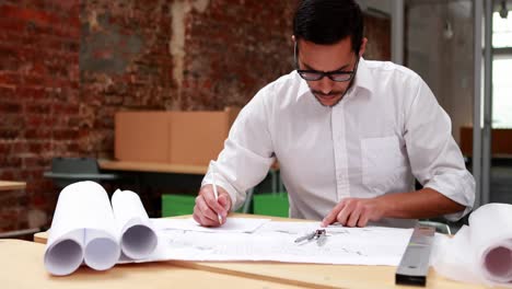 young architect going over blueprints