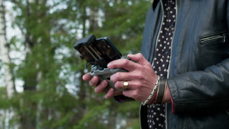 strong caucasian hands operating a remote controller of a drone