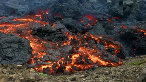 Hot-Lava-Slowly-Flowing-In-Land-From-Fagradalsfjall-Volcano---close-up-shot