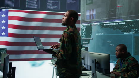 profesionales en los estados unidos uniformes militares operan computadoras y pantallas grandes