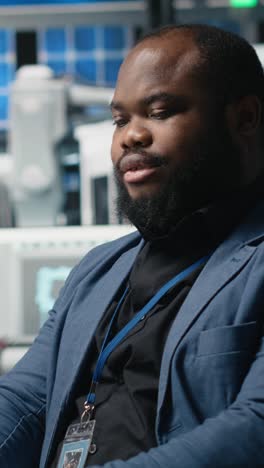 vertical video industrial specialist handling the assembling process on computer