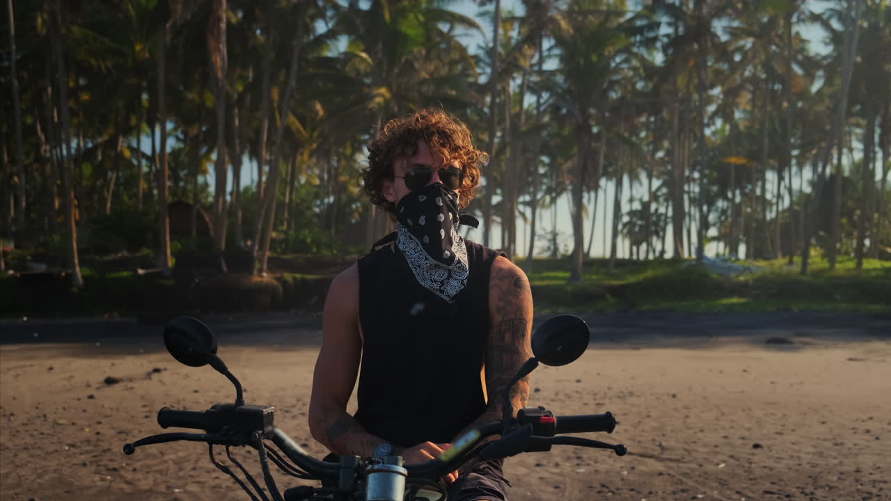 Man on Motorcycle on a Tropical Beach