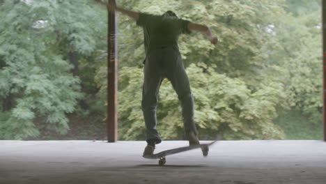 caucasian boy skateboarding in a ruined building.