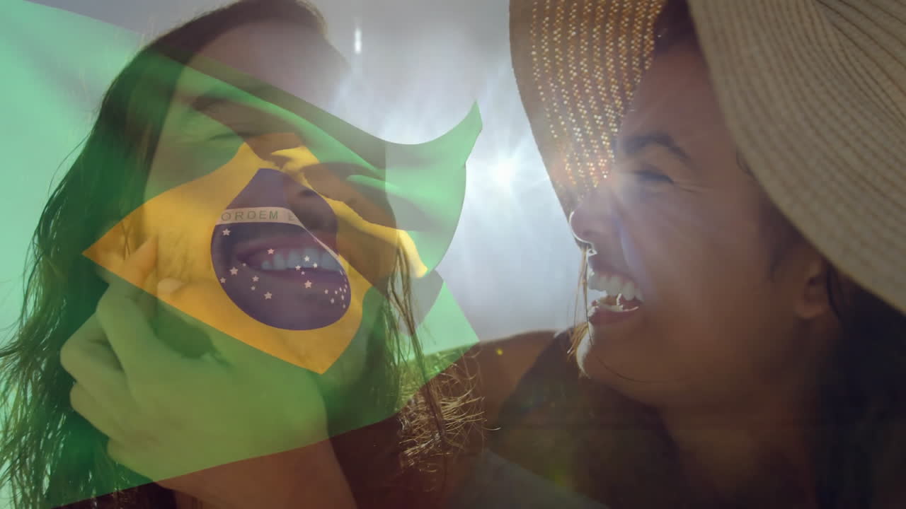 Holding Brazilian flag overlay, women smiling with sunlight in background