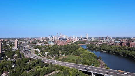 A-side-view-of-the-highway,-minneapolis-skyline,-and-the-mississippi-river-in-a-single-drone-shot