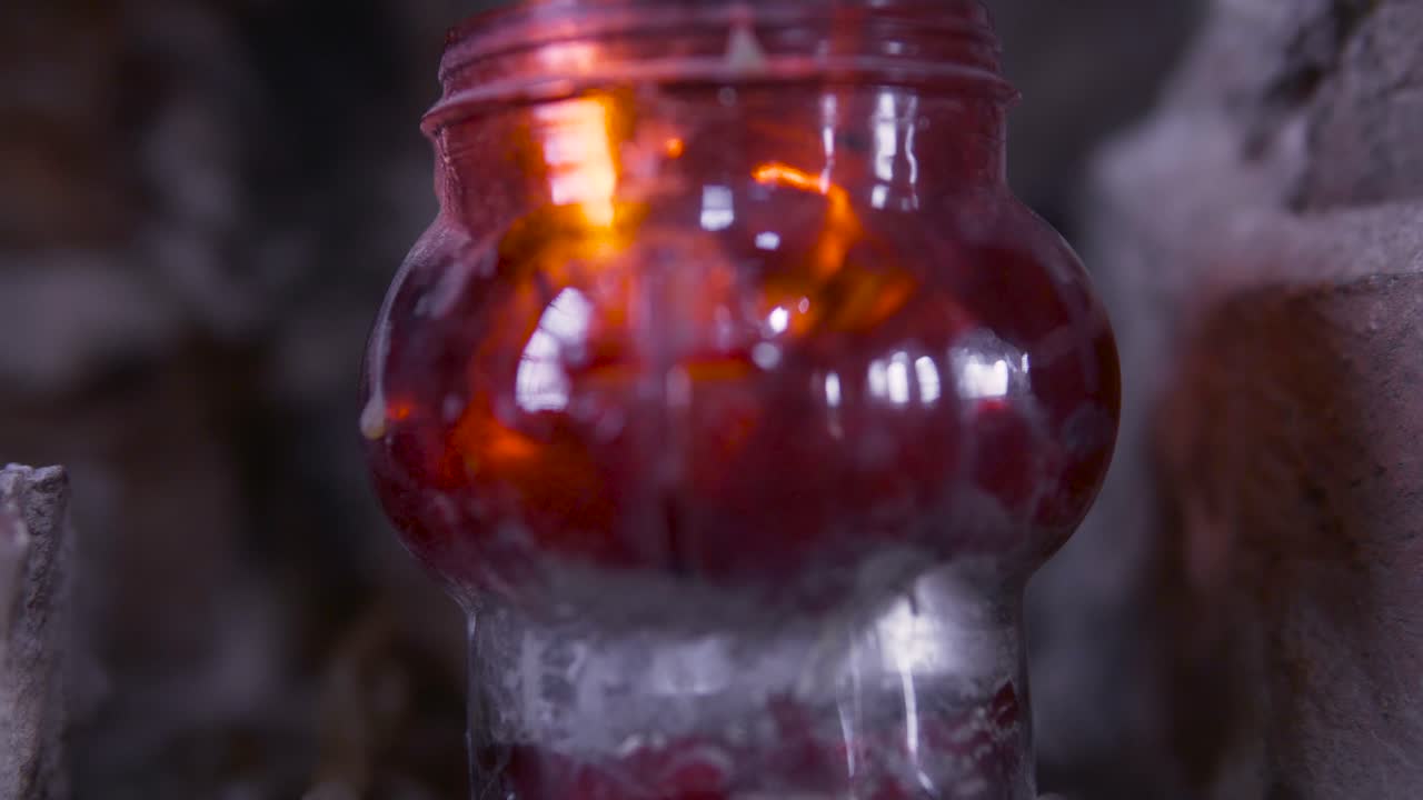 горящая свеча в нише.