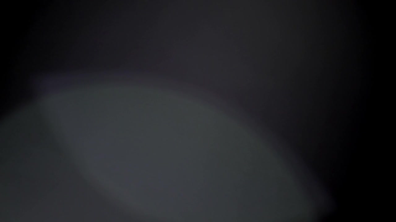 Subtle Optical Light Leaks and Lens Flares on Black Background