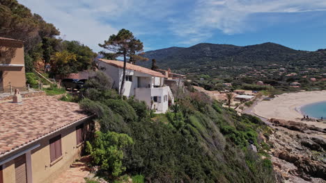 house on cliff overlooking ocean