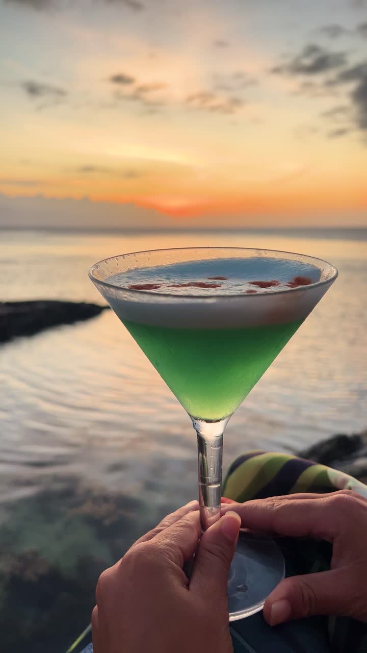 Tropical cocktail at sunset with serene Fijian ocean backdrop
