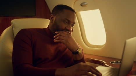 happy guy checking online reports making yes gesture at airplane window closeup.