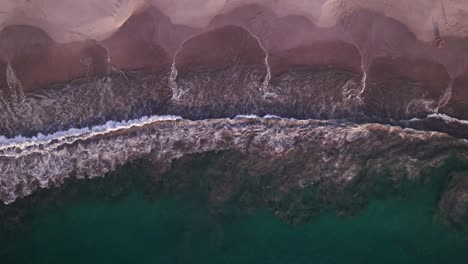 Experience-the-mesmerizing-dance-of-ocean-waves-from-above,-a-stunning-aerial-view-of-nature's-rhythm