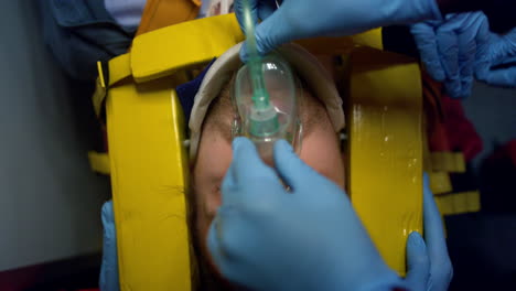 doctors hands saving life of patient. paramedics fixing man head in immobilizer