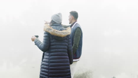 couple, holding hands and walking in misty fog