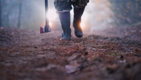 a murderer with a bloody ax on a forest road stands in the light of car headlights creepy crime scen