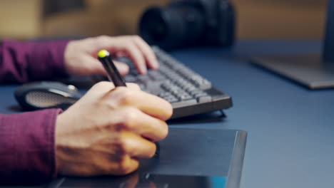 close up of creative photographer using graphic tablet