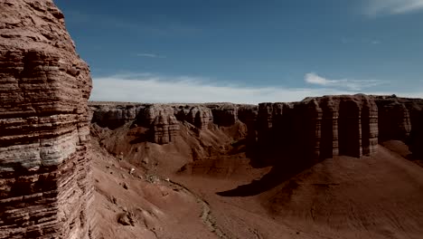 Vuelo-Por-Acantilados-De-Arenisca-Roja-Para-Revelar-El-Paisaje-Del-Desierto