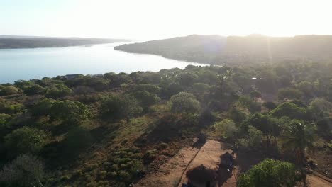 low flying aerial shot of mozambican tribal village in chidenguele area