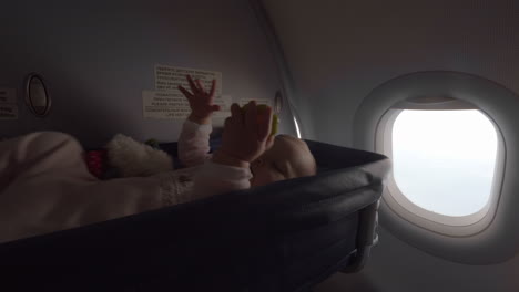 Baby-in-a-cot-bassinet-on-an-airplane