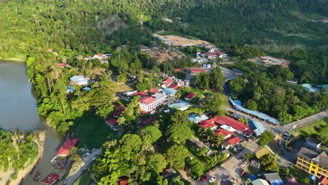 orbiting aerial view of kuala tahan, a malaysian village at the tembeling river in taman negara national park during the day in peninsular malaysia.
