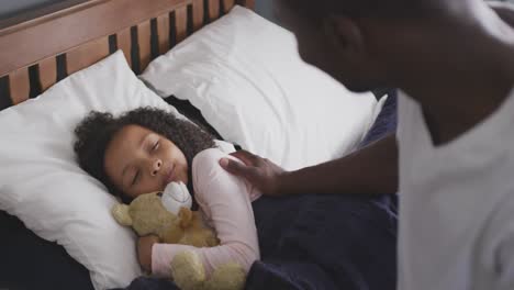 african american father waking up his daughter