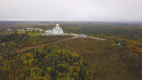 aerial view of a church on a hilltop in autumn