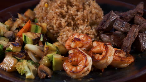 mixed meat hibachi plate, shrimp vegetable steak fried rice piled on plate, slider close up 4k