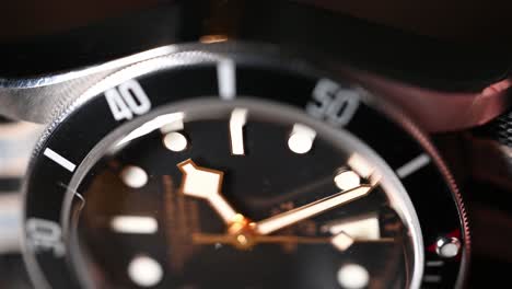 luxury high-end automatic wristwatch on its side, second hand moving