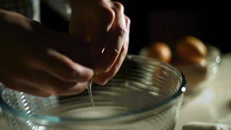 chef hand breaking eggs. male hand cracked eggs. food preparation