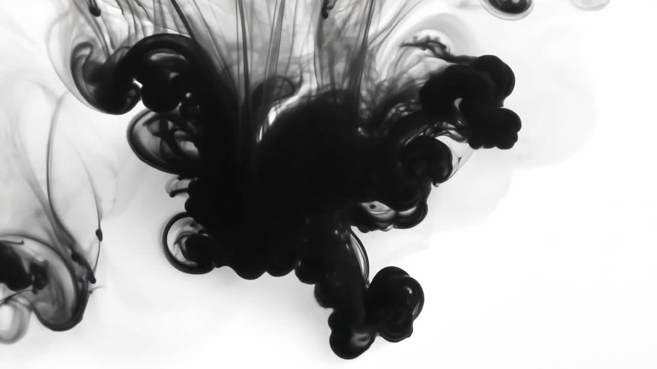 Black ink expands in water, creating a stunning abstract effect against a white background