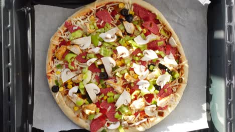 homemade pizza with chicken, pepperoni, mushrooms, and green peppers